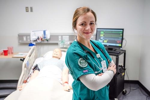Nursing student poses in a hospital room
